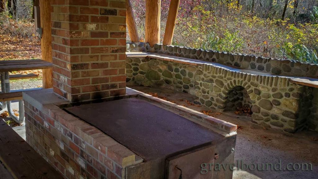 Brick and metal fireplace and flat top grill surface